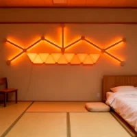 RGBIC multi-color mini triangle panels with LED bars for modular wall lighting in gaming rooms, streaming setups, and modern home décor by Gaming Hexagon Lights